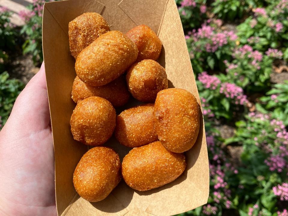 hand holding boat of casey's corner corn dog nuggets disney world