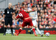 <p>Roberto Firmino and Chris Smalling get stuck in</p>