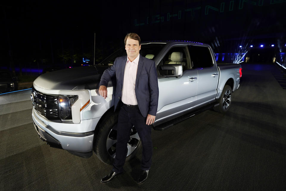 Jim Farley, Ford Motor Company's chief executive officer, stands next to the company's new Ford F-150 Lightning, Wednesday, May 19, 2021, in Dearborn, Mich. On the outside, the electric version of Ford's F-150 pickup looks about the same as the wildly popular gas-powered truck. The new truck called the F-150 Lightning can go up to 300 miles per charge, with a starting price of just under $40,000. (AP Photo/Carlos Osorio)