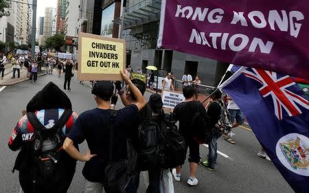 Pro-independence protesters carry placard and flags during a pro-democracy march on the day marking the 19th anniversary of Hong Kong's handover to Chinese sovereignty from British rule, in Hong Kong in this file photo dated July 1, 2016. REUTERS/Bobby Yip