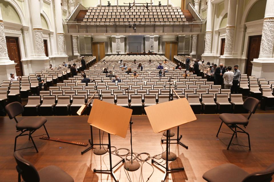 People wearing masks and observing safe distancing attend the first live concert by Singapore Symphony Orchestra since the implementation of preventive measures against COVID-19 at the Victoria Concert Hall in Singapore.