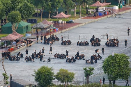 Chinese soldiers eat on the grounds of the Shenzhen Bay Sports Center in Shenzhen across the bay from Hong Kong