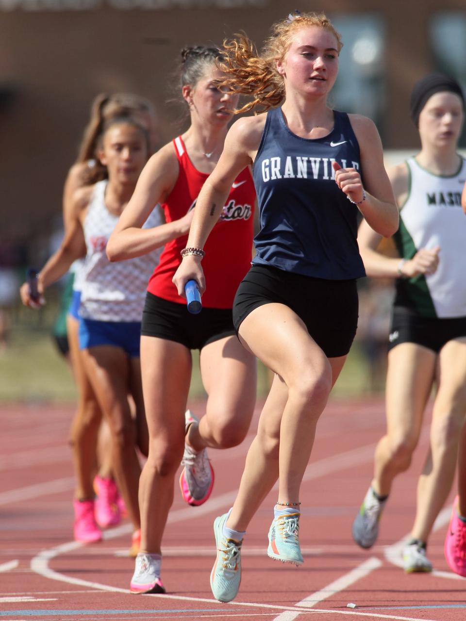 Granville's Kara Bergeron carries the baton for the second leg of the Division I girls 3,200 relay during the state championships on Friday.