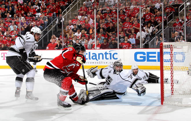  Zach Parise #9 Of The New Jersey Devils Goes For The Puck In Front Of Jonathan Quick #32 Of The Los Angeles Kings As  Getty Images