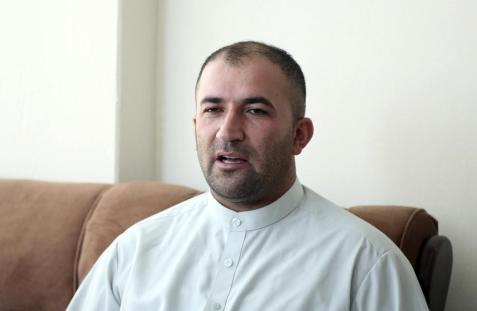In this Sunday, Oct. 14, 2018 photo, Bilal, the husband of Hameeda Danesh, who is running for a seat in Afghanistan’s Parliament, speaks during an interview with The Associated Press in Kabul, Afghanistan. Danesh is competing against six men to represent the deeply conservative district of Jalrez in Afghanistan’s central Wardak province. Bilal said he admires his wife’s fierce independence, but worries when she sets out from their home in the capital Kabul to travel to Wardak province, about 40 kilometers (24 miles) away. (AP Photo/Rahmat Gul)