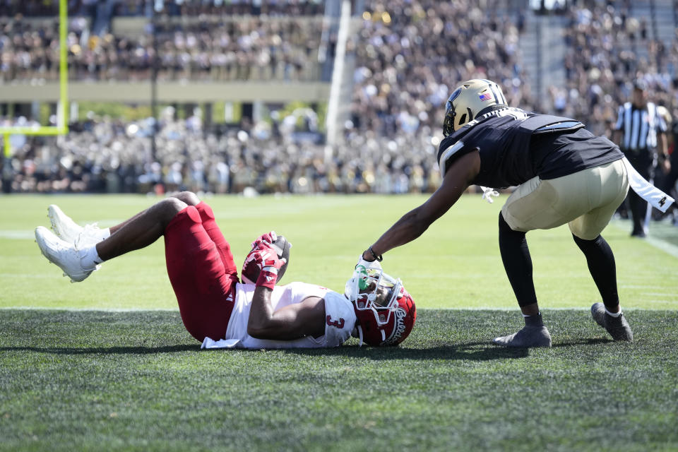 Fresno State wide receiver Erik Brooks (3) gets his mask grabbed by Purdue defensive back Markevious Brown (1) after scoring a touchdown against Purdue during the second half of an NCAA college football game in West Lafayette, Ind., Saturday, Sept. 2, 2023. Fresno State won 38-35. (AP Photo/AJ Mast)