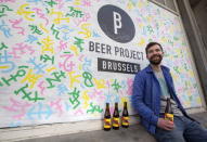 Sebastien Morvan, one of the founders of microbrewery Brussels Beer Project, displays bottles of beer called Babylone outside his office in central Brussels April 14, 2015. REUTERS/Yves Herman