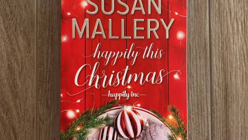 The cover of the romance novel “Happily This Christmas” by Susan Mallery.