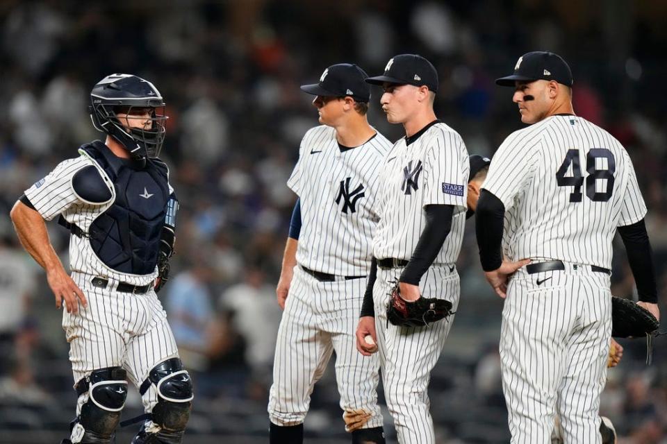 New York Yankees relief pitcher Ron Marinaccio, second from right, reacts with teammates Anthony Rizzo, right, DJ LeMahieu, second from left, and catcher Kyle Higashioka during the ninth inning of a baseball game against the New York Mets, Tuesday, July 25, 2023, in New York. (AP Photo/Frank Franklin II)