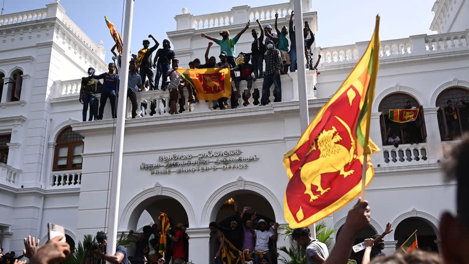 Demonstrators shout slogans and wave Sri Lankan flags during an anti-government protest inside the office building of Sri Lanka's prime minister in Colombo on July 13, 2022. - Arun Sankar/AFP/Getty Images/File