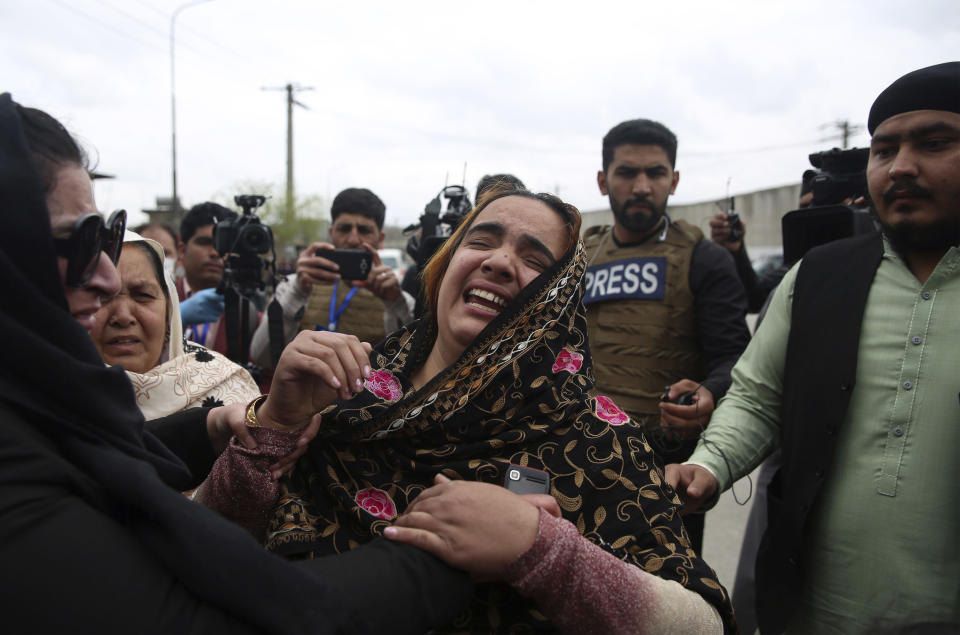 FILE- in this Wednesday, March 25, 2020, photo, family members cry after an attack in Kabul, Afghanistan. Pakistan asked neighbor Afghanistan to extradite Aslam Farooqi, a leader of the local Islamic State affiliate, who was arrested in an Afghan intelligence operation in southern Afghanistan earlier this month. (AP Photo/Rahmat Gul, file)