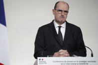 French Prime Minister Jean Castex grimaces during a press conference to outline France's strategy for the deployment of future COVID-19 vaccines, in Paris, Thursday Dec. 3, 2020. French Prime Minister Jean Castex said the first doses of COVID-19 vaccines will go to nursing homes residents when they will be available in the country, not before the end of the month. (Benoit Tessier/Pool via AP)