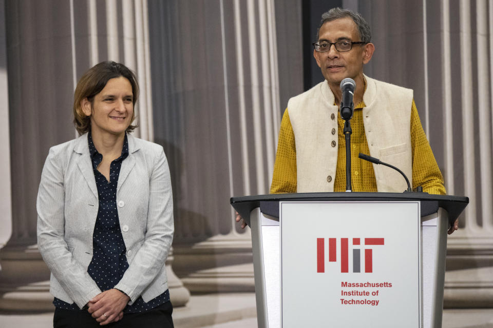 Abhijit Banerjee, right, talks during a news conference with Esther Duflo at Massachusetts Institute of Technology in Cambridge, Mass., Monday, Oct. 14, 2019. Banerjee and Duflo, along with Harvard's Michael Kremer, were awarded the 2019 Nobel Prize in economics for pioneering new ways to alleviate global poverty. (AP Photo/Michael Dwyer)