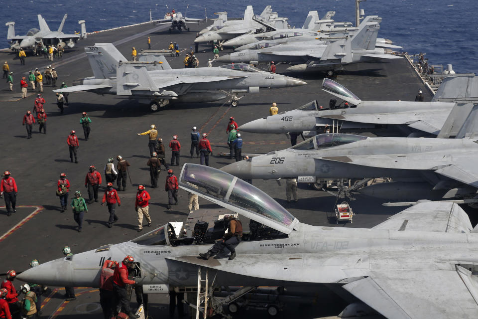 The F/A-18 Super Hornet fighter jets are seen on the deck of the U.S. Navy USS Ronald Reagan in the South China Sea, Tuesday, Nov. 20, 2018. China is allowing a U.S. Navy aircraft carrier and its battle group to make a port call in Hong Kong after it turned down similar request amid tensions with Washington. (AP Photo/Kin Cheung)