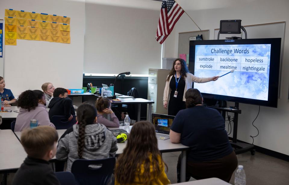 Teacher Angela Mosca points to a vowel in a word during a reading skills lesson in at Mary Eyre Elementary School in Salem, Ore., on Tuesday, April 26, 2022.