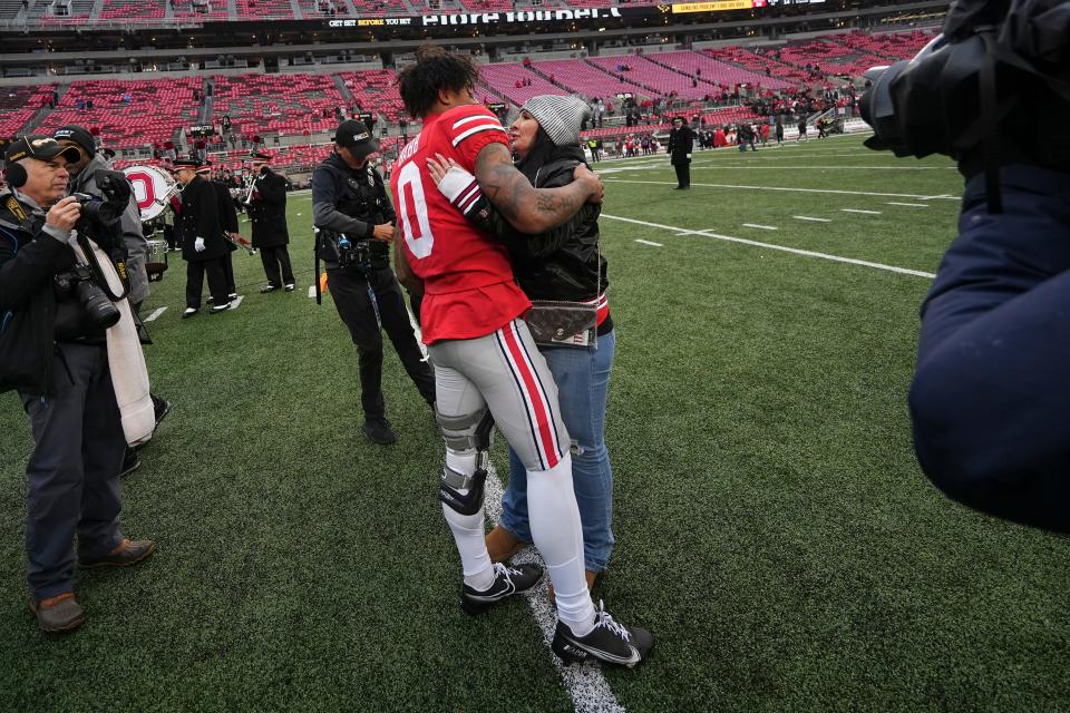 Ohio State wide receiver Kamryn Babb hugs his mom, Alana Templeton, following the Buckeyes' 56-14 win over Indiana.