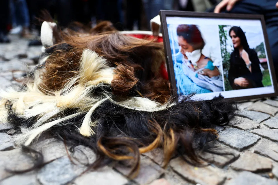 <p>A pile of hair is seen after demonstrators cut their hair during a protest following the death of Mahsa Amini, in front of the Brandenburg Gate in Berlin, Germany, September 23, 2022. REUTERS/Christian Mang</p> 