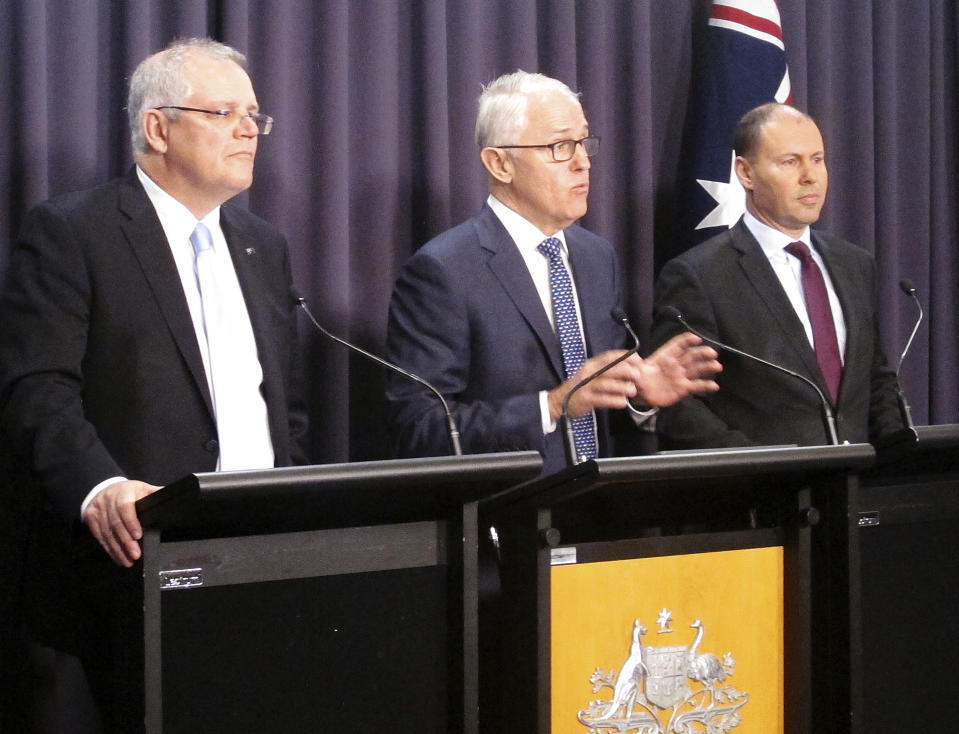 Australian Prime Minister Malcolm Turnbull, center, Treasurer Scott Morrison, left, and Environment Minister Josh Frydenberg address reporters at Parliament House in Canberra, Australia, Monday, Aug. 20, 2018. Turnbull abandoned plans to legislate to limit greenhouse gas emissions to head off a revolt by conservative lawmakers. Turnbull conceded that he could not get legislation through the House of Representatives where his conservative coalition holds only a single-seat majority. (AP Photo/Rod McGuirk)