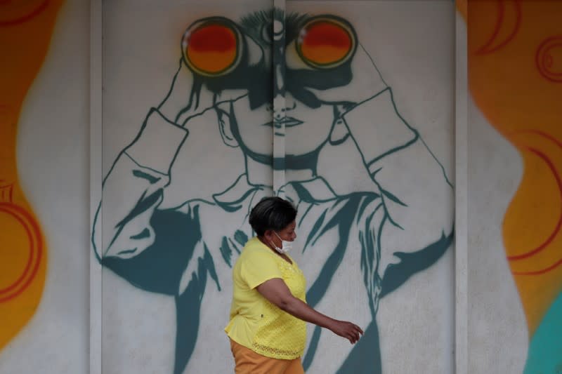 A woman walks as she wears a protective mask during the coronavirus disease (COVID-19) outbreak in Brasilia