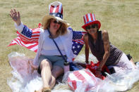 Anna "AJ" Prospect and Julie Costello of Apple Valley, Minn., were among supporters of former President Donald Trump who attended a rally organized by pillow salesman-turned conspiracy peddler Mike Lindell in New Richmond, Wis., on Saturday, June 12, 2021. Prospect says she became more politically active because of the pandemic. For a few hours last weekend, thousands of Donald Trump’s loyal supporters came together under the blazing sun in a field in Western Wisconsin to live in an alternate reality where the former president was still in office — or would soon return. (AP Photo/Jill Colvin)