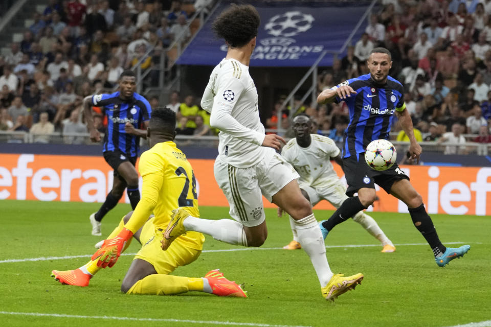 Bayern's Leroy Sane watches Inter Milan's Danilo D'Ambrosio, right, scoring an own goal to give Bayern a 2-0 lead, during the Champions League, group C soccer match between Inter Milan and Bayern Munich, at the Milan San Siro stadium, Italy, Wednesday, Sept. 7, 2022. (AP Photo/Luca Bruno)