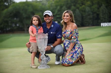 Aug 30, 2015; Edison, NJ, USA; Jason Day, along with his son Dash and his wife Ellie, pose with the Barclays Championship trophy at Plainfield Country Club. Mandatory Credit: Eric Sucar-USA TODAY Sports