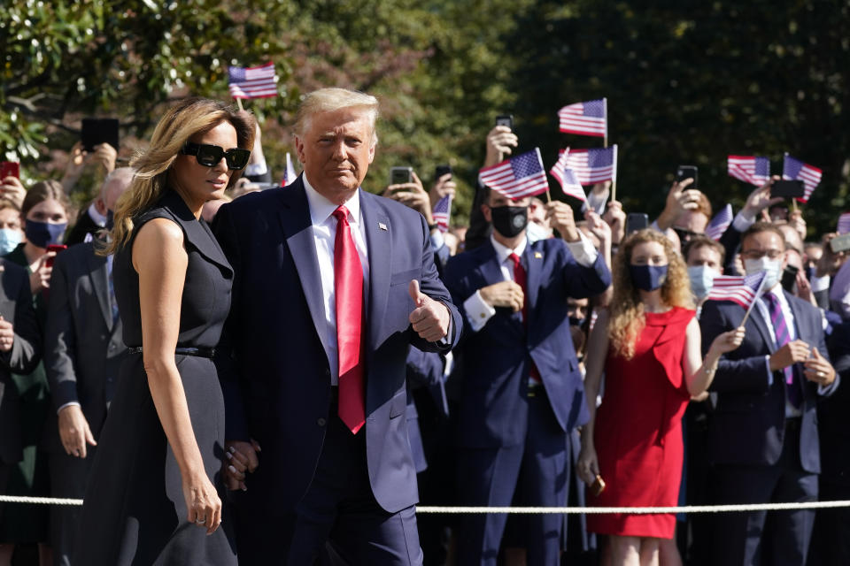 President Donald Trump and first lady Melania Trump pause as they walk to board Marine One on the South Lawn of the White House, Thursday, Oct. 22, 2020, in Washington. Trump is headed to Nashville, Tenn., for a debate. (AP Photo/Alex Brandon)