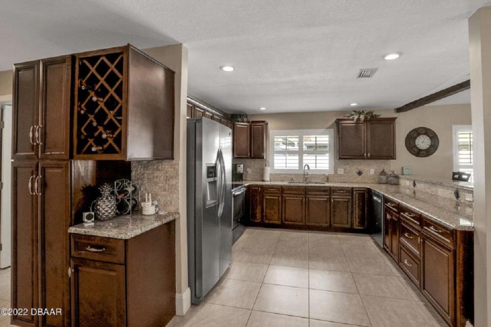 The chef-inspired kitchen is equipped with granite countertops, stainless-steel appliances, tons of cabinet and counter space, a large bar and a breakfast nook.