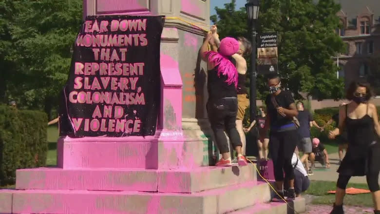 Protesters poured pink paint on the statues of Sir. John A. Macdonald at Queen's Park and on Egerton Ryerson at Ryerson University on Saturday morning. (Keith Burgess/CBC)