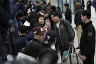 San Diego Padres player Woo-Suk Go, right, interacts with fans as he arrives at the Incheon International Airport In Incheon, South Korea, Friday, March 15, 2024. (AP Photo/Ahn Young-joon)