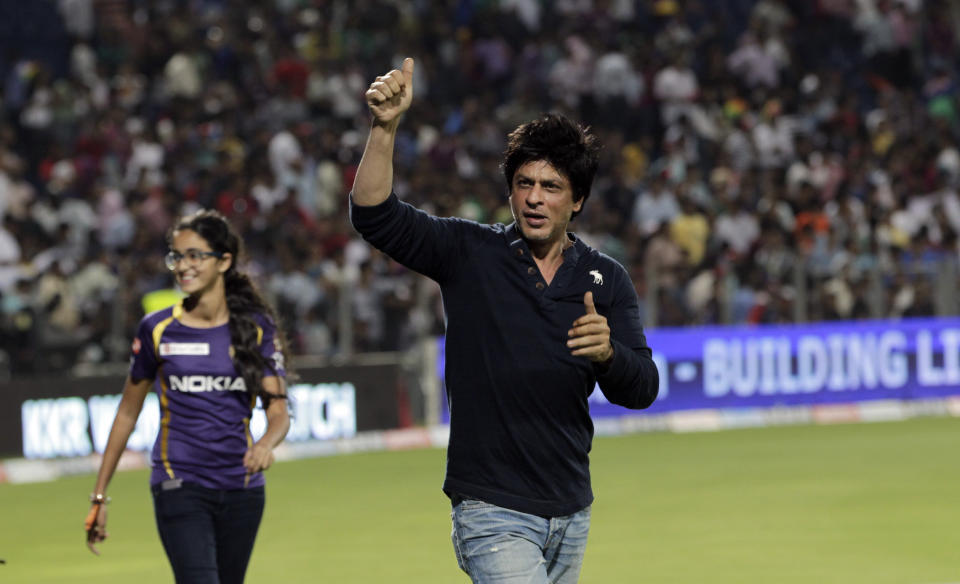 Kolkata Knight Riders' co owner and Bollywood star Shah Rukh Khan, center celebrates after his team won their Indian Premier League (IPL) cricket playoff match against Delhi Daredevils in Pune, India, Tuesday, May 22, 2012. (AP Photo/Rajanish Kakade)