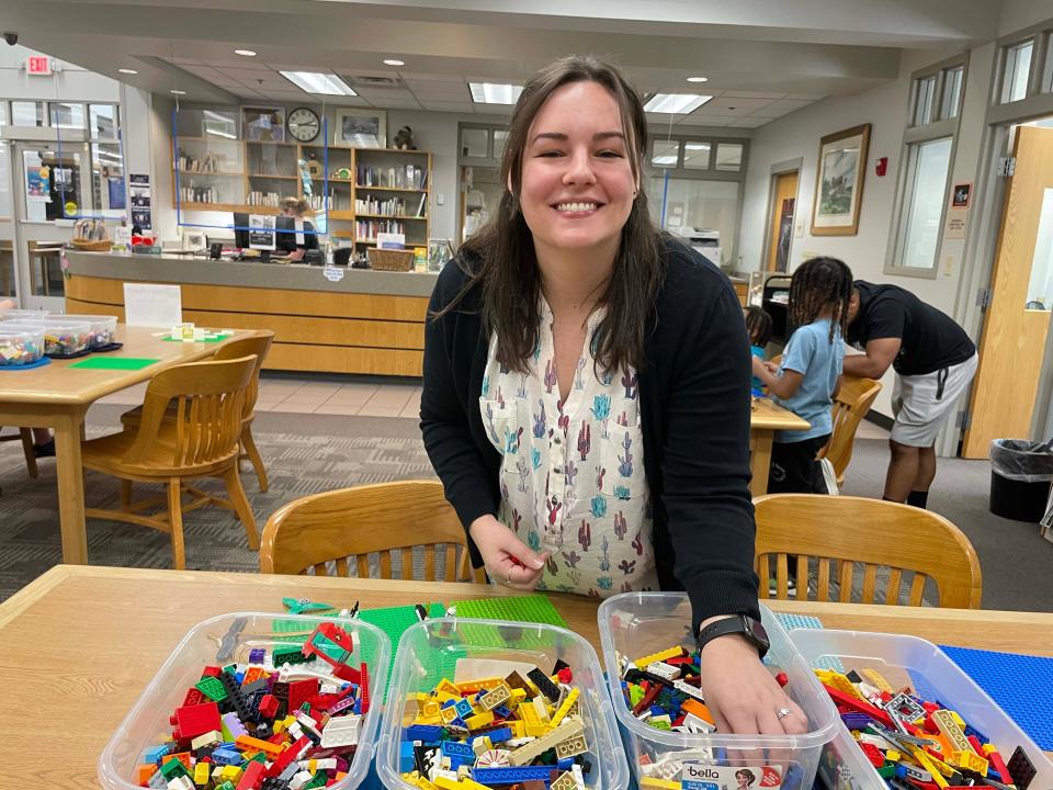 Desk Assistant Paula Davis organizes a few of the 14 bins of LEGOs at the monthly LEGO Club at Karns Branch Library Saturday, May 21, 2022. She said the LEGO Club was one of her favorite activities because she gets to see creativity in motion.