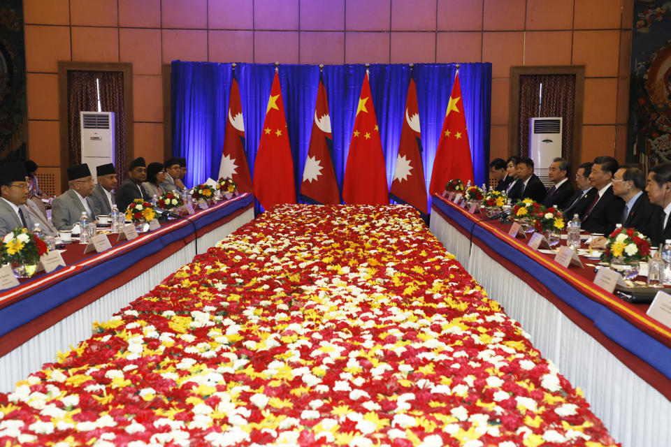 Chinese President Xi Jinping, third right and Nepalese Prime Minister Khadga Prasad Oli, left sit face to face during a bilateral meeting in Kathmandu, Nepal, Sunday, Oct. 13, 2019. Xi on Saturday became the first Chinese president in more than two decades to visit Nepal, where he's expected to sign agreements on some infrastructure projects. (Bikash Dware/The Rising Nepal via AP)