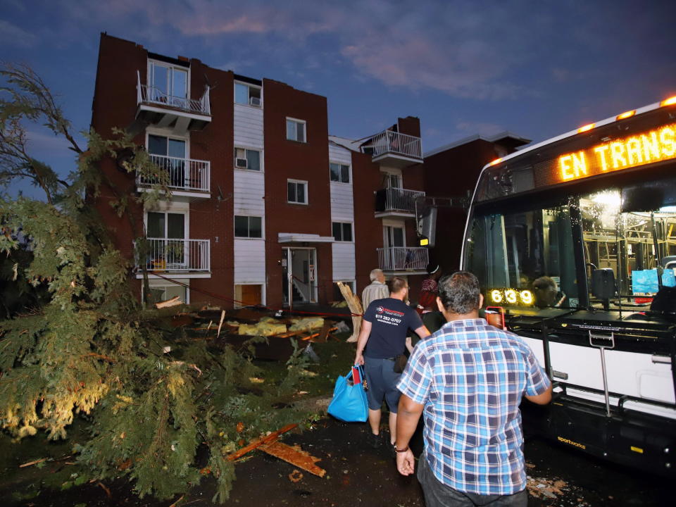 <p>Residents board buses after apartment buildings had roofs torn off and windows blown out after a tornado caused extensive damage to a Gatineau, Quebec neighbourhood forcing hundreds of families to evacuate their homes on Friday, September 21, 2018. A tornado damaged cars in Gatineau, Que., and houses in a community west of Ottawa on Friday afternoon as much of southern Ontario saw severe thunderstorms and high wind gusts, Environment Canada said. (Photo from Fred Chartrand/The Canadian Press) </p>