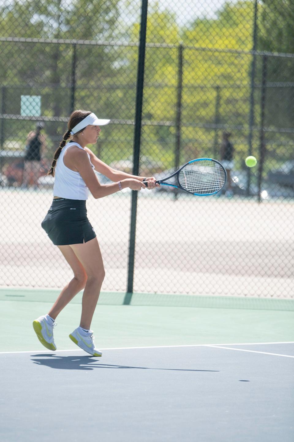 Pueblo East's Ava Andrada backhands a return during the No. 1 singles final of the Class 3A Region 7 tournament at Pueblo City Park on Friday, May 3, 2024.
