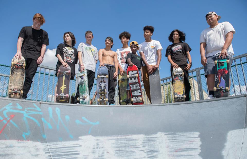 A diverse crew of skateboarders stand on a ramp during a skateboard session at the Pennsauken skate park on Tuesday, June 15, 2021.  