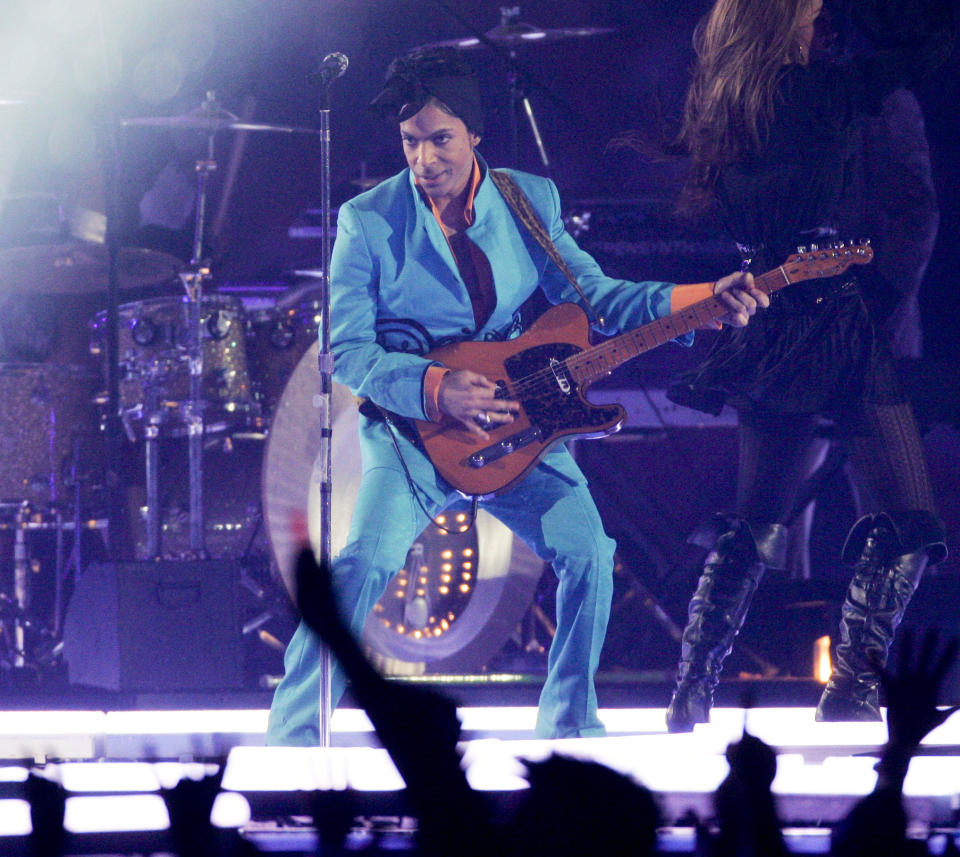 FILE - Prince performs during the halftime show at the Super Bowl XLI NFL football game at Dolphin Stadium in Miami on Sunday, Feb. 4, 2007. When the Super Bowl halftime show was born, high school and college marching bands took center field. But over the years, the intermission during the NFL’s championship game has turned into one of sports’ biggest spectacles with superstar performances. (AP Photo/Mark J. Terrill, File)