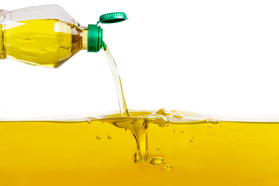 Vegetable oil pouring on vegetable oil background