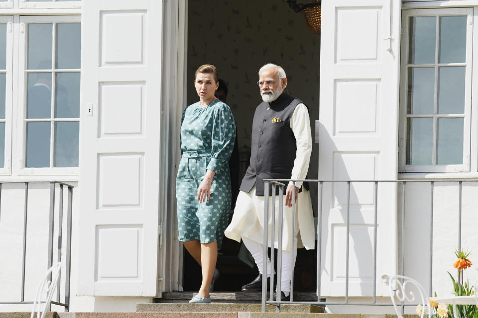 Danish Prime Minister Mette Frederiksen, left, and Indian Prime Minister Narendra Modi, walk out of the prime minister's official residence Marienborg, in Kongens Lyngby, north of Copenhagen, Denmark, Tuesday, May 3, 2022. Modi is on a two-day visit to Denmark. (Martin Sylvest/Ritzau Scanpix via AP)