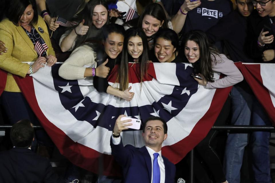 <div class="inline-image__caption"><p>Democratic presidential candidate and former South Bend, Ind., Mayor Pete Buttigieg took a selfie with supporters after speaking at a caucus night campaign rally, Monday, Feb. 3, 2020, in Des Moines, Iowa. Buttigieg made history as the first openly gay presidential candidate—and will make history again when President Biden takes office as the first LGBTQ cabinet member in U.S. history.</p></div> <div class="inline-image__credit">Charlie Neibergall/AP</div>