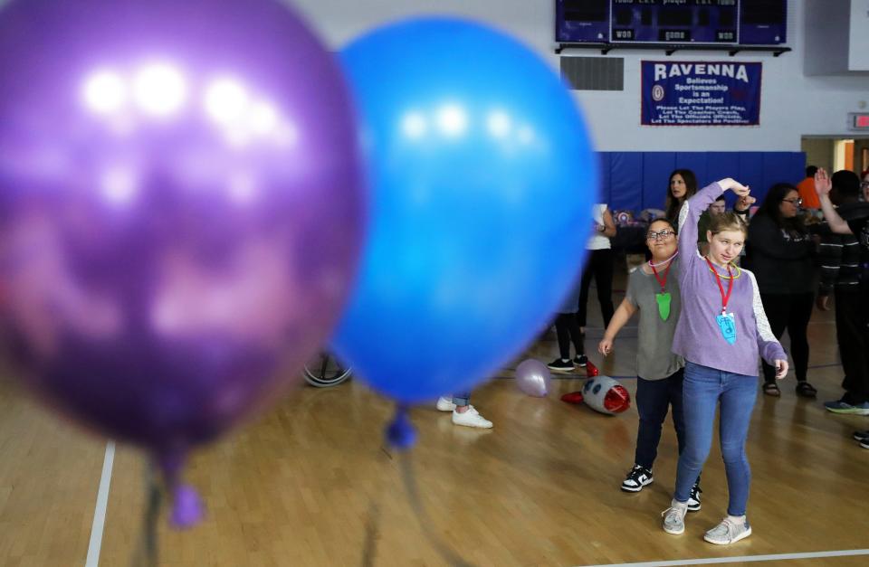 Dover High School students Zilynn Zedi, left, and Kensington Fisher, right, dance during the “Out of This World” dance party Friday, May 10, 2024, at Ravenna High School.