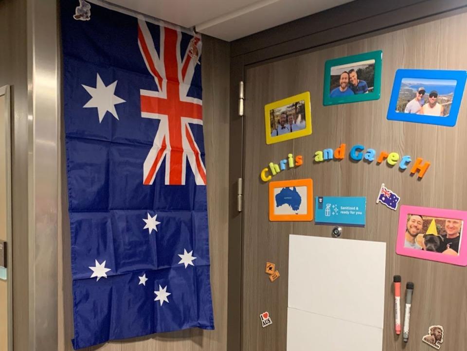 ad door with a white board and photos and australian flag on a cruise