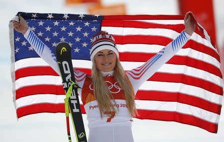 Alpine Skiing - Pyeongchang 2018 Winter Olympics - Women's Downhill - Jeongseon Alpine Centre - Pyeongchang, South Korea - February 21, 2018 - Bronze medallist Lindsey Vonn of the U.S. celebrates during the flower ceremony. REUTERS/Leonhard Foeger