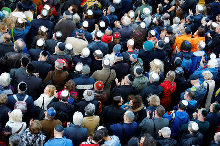 People wear kippas as they attend a demonstration in front of a Jewish synagogue, to denounce an anti-Semitic attack on a young man wearing a kippa in the capital earlier this month, in Berlin, Germany, April 25, 2018. REUTERS/Fabrizio Bensch