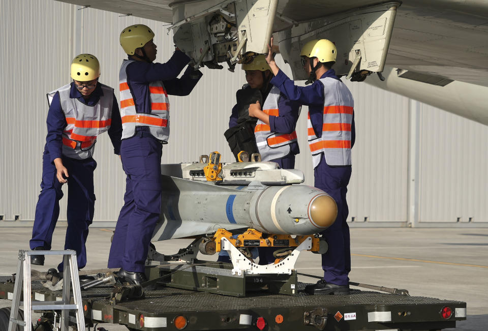 Taiwanese soldiers load a AGM-65 Maverick air to ground missile on a P-3 submarine hunter aircraft at an airbase in southern Taiwan's Pingtung county on Tuesday, Jan. 30, 2024. Taiwan is holding spring military drills following its recent presidential election and amid threats from China, which claims the island as its own territory that it is determined to annex, possibly by force.(AP Photo/Johnson Lai)