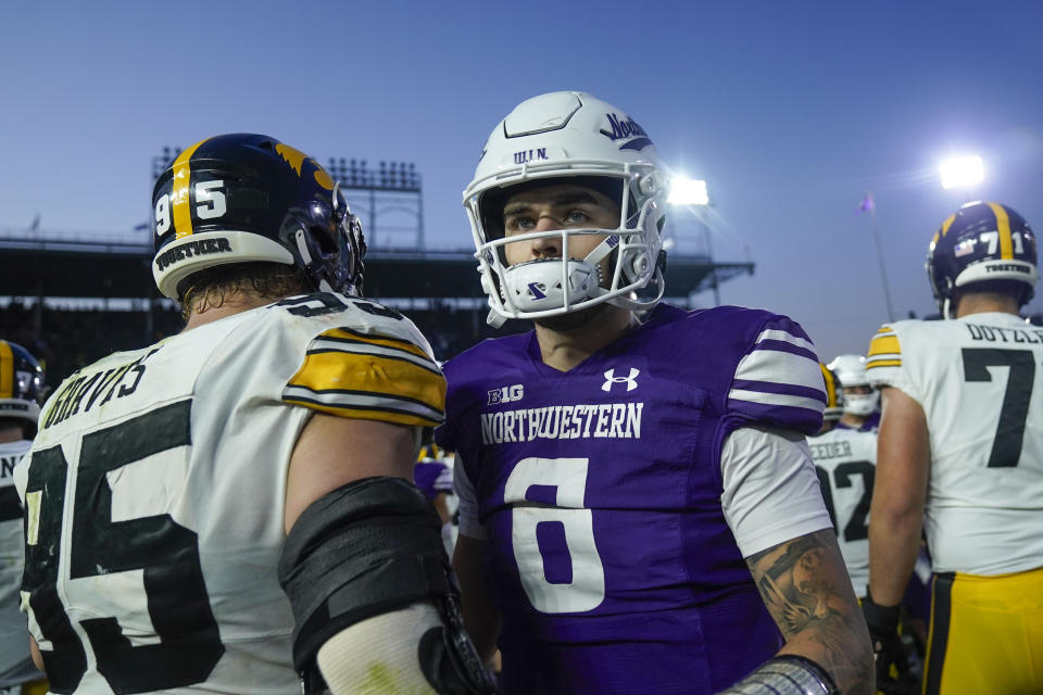 Northwestern quarterback Brendan Sullivan, front right, greets Iowa players after his team's loss in an NCAA college football game Saturday, Nov. 4, 2023, at Wrigley Field in Chicago. (AP Photo/Erin Hooley)