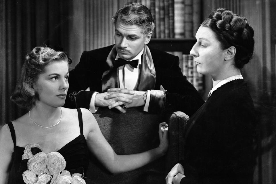 1940: Joan Fontaine, playing the second Mrs de Winter, with her screen husband Laurence Olivier and the intimidating house keeper Mrs Danvers portrayed by Judith Anderson. (Photo via John Kobal Foundation/Getty Images)
