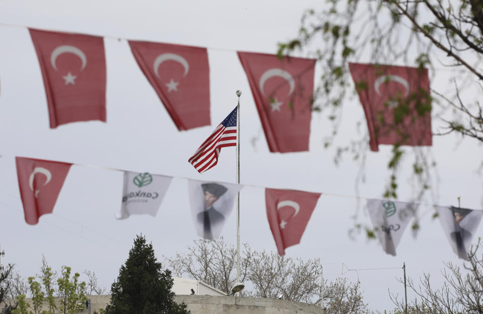 Turkish flags and banners depicting Mustafa Kemal Ataturk, the founder of modern Turkey, decorate a street outside the United States embassy in Ankara, Turkey, Sunday, April 25, 2021. Turkey's foreign ministry has summoned the U.S. Ambassador in Ankara to protest the U.S. decision to mark the deportation and killing of Armenians during the Ottoman Empire as "genocide." On Saturday, U.S. President Joe Biden followed through on a campaign promise to recognize the events that began in 1915 and killed an estimated 1.5 million Ottoman Armenians as genocide. (AP Photo/Burhan Ozbilici)