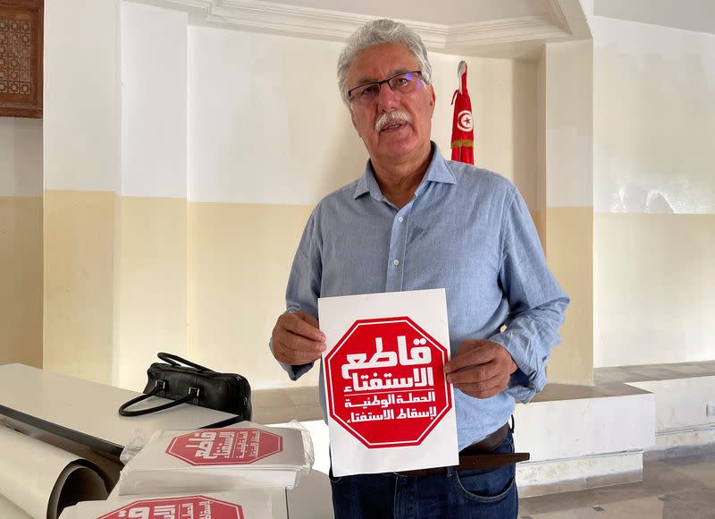 Hamma al-Hammami, a leftist activist and former political prisoner, displays a flyer during an interview with Reuters in Tunis