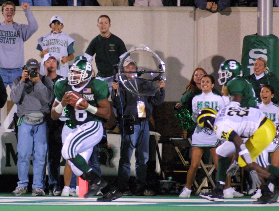 Michigan State's T.J. Duckett, left, catches the winning touchdown against Michigan's Marlin Jackson, right, with no time remaining on the clock, Nov. 3, 2001, in East Lansing. Michigan State beat Michigan 26-24.